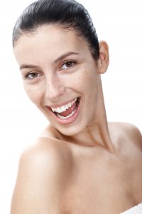 Natural smiling woman with sunspots