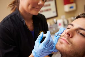 Man Having Botox Treatment At Beauty Clinic