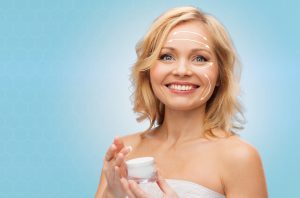 happy woman with cream jar