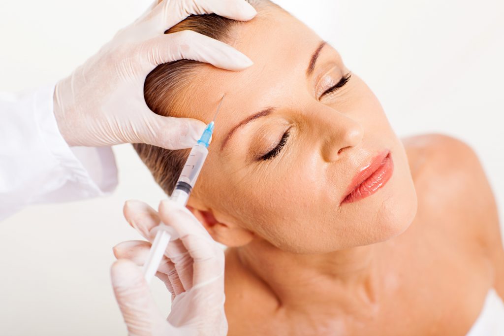 doctor giving face lifting injection