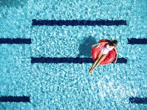 Woman relaxing with lilo in pool