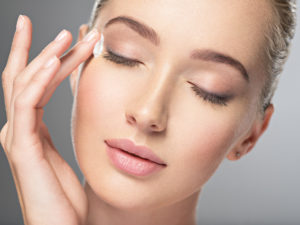 Woman with her hands resting on her face