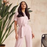 woman wear pink suit pants in the office
