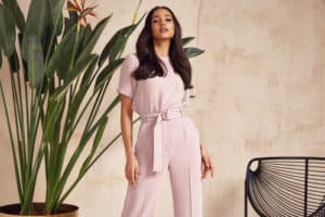 woman wear pink suit pants in the office