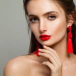 Woman with Red Lips Makeup and Jewelry Earrings
