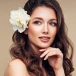 Beautiful portrait of young girl with flower in her hair